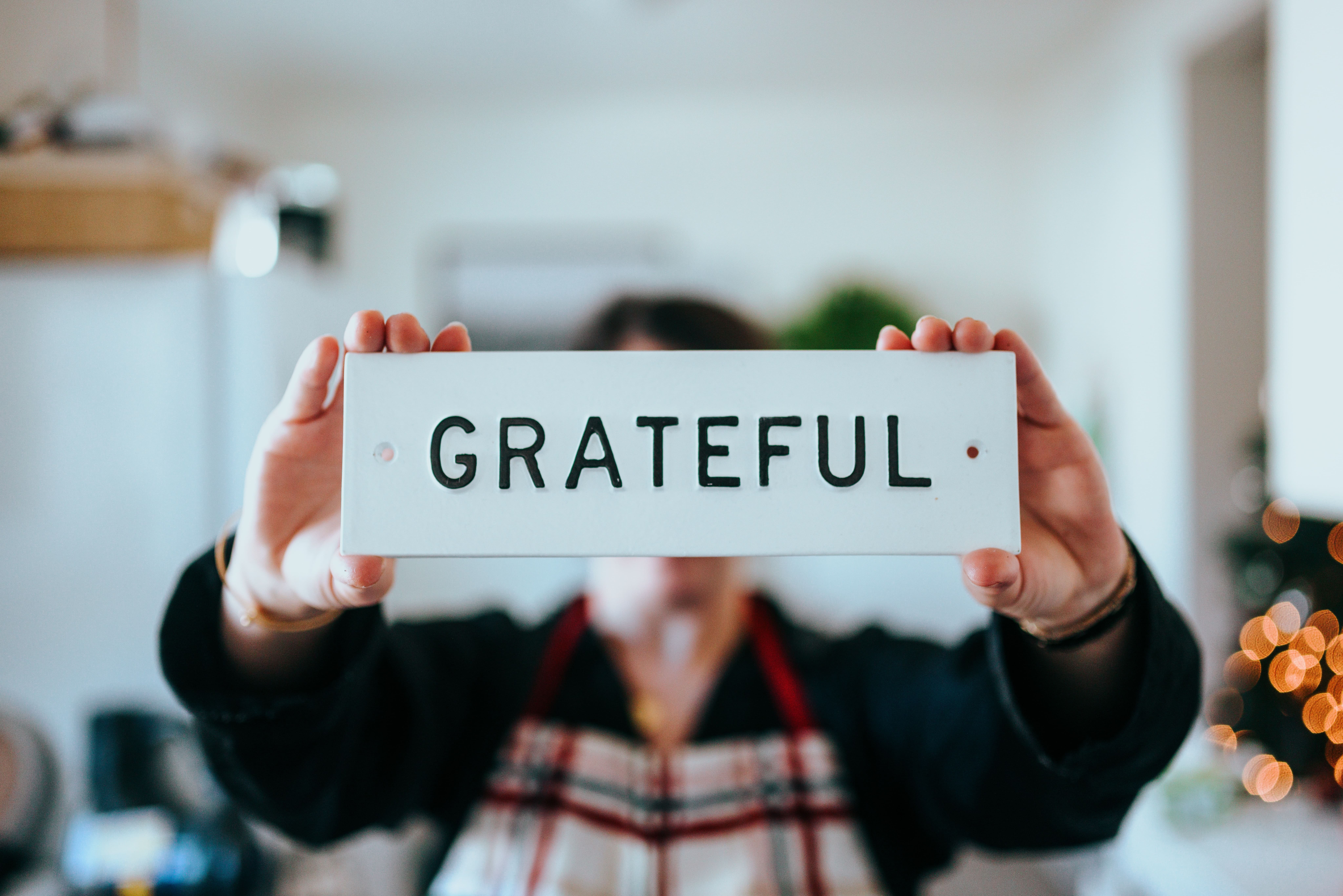 Person holding grateful sign