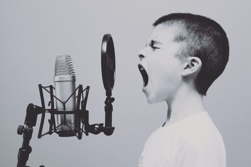 child shouting into microphone listen